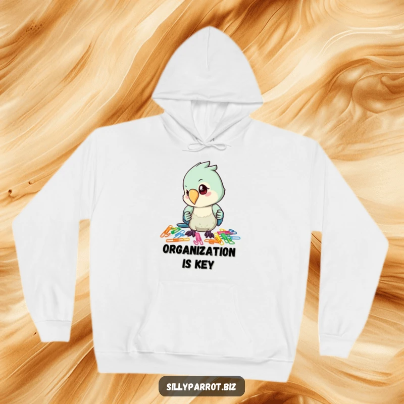 Funny hoodie design featuring a parrot intently organizing a pile of colorful paper clips, radiating focus and calm.