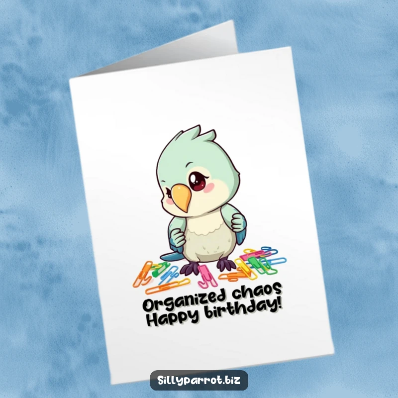 Funny Free Printable Birthday Card: Focused parrot character meticulously sorts colorful paper clips with hilarious dedication.
